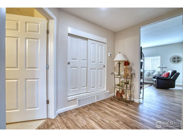 a view of a livingroom with wooden floor closet and windows