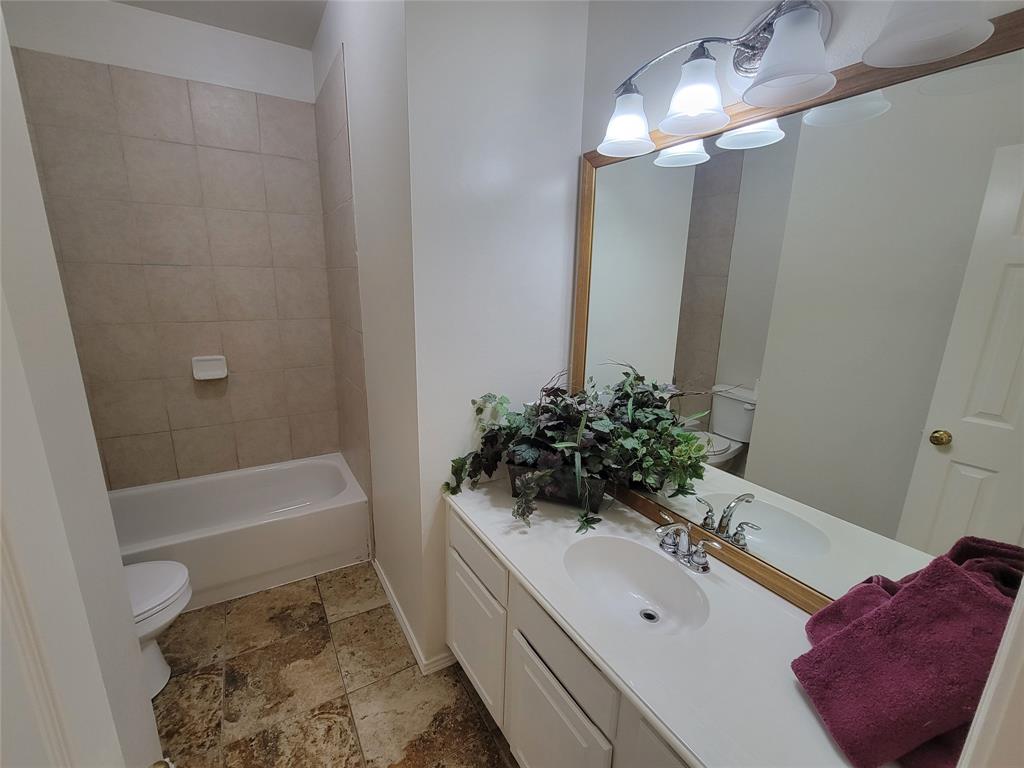 2913 Rush Creek Road McKinney, TX 75072 - Photo 11 of 32 Full bathroom with vanity, tiled shower / bath, toilet, and tile flooring
