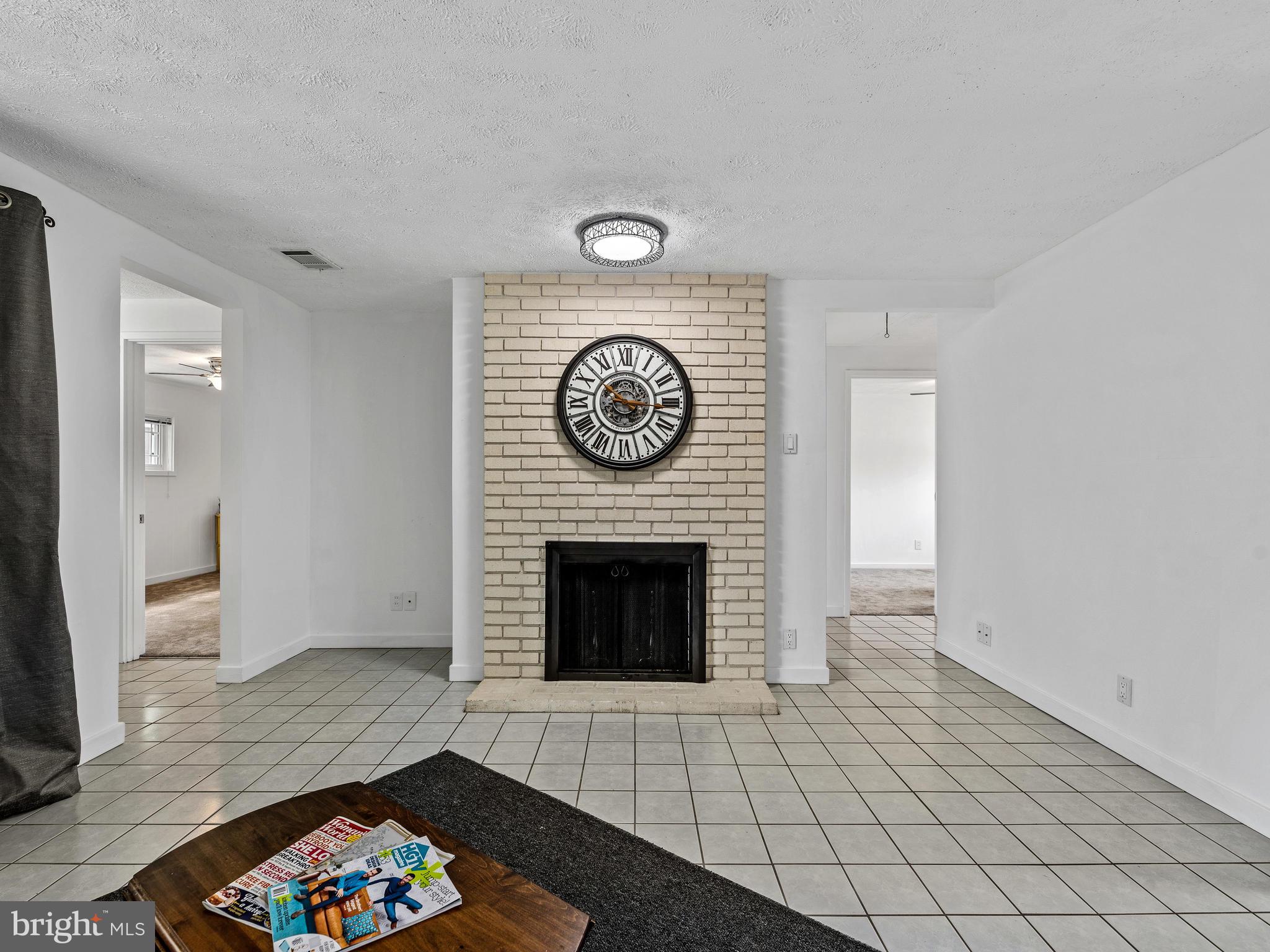 Wood burning brick fireplace and TV alcove on left