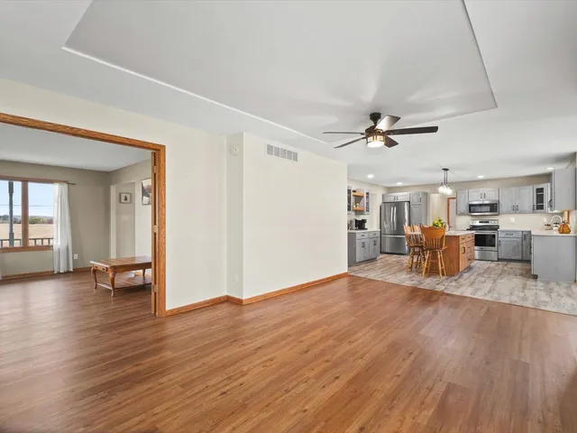 a view of a livingroom with hardwood floor and a ceiling fan