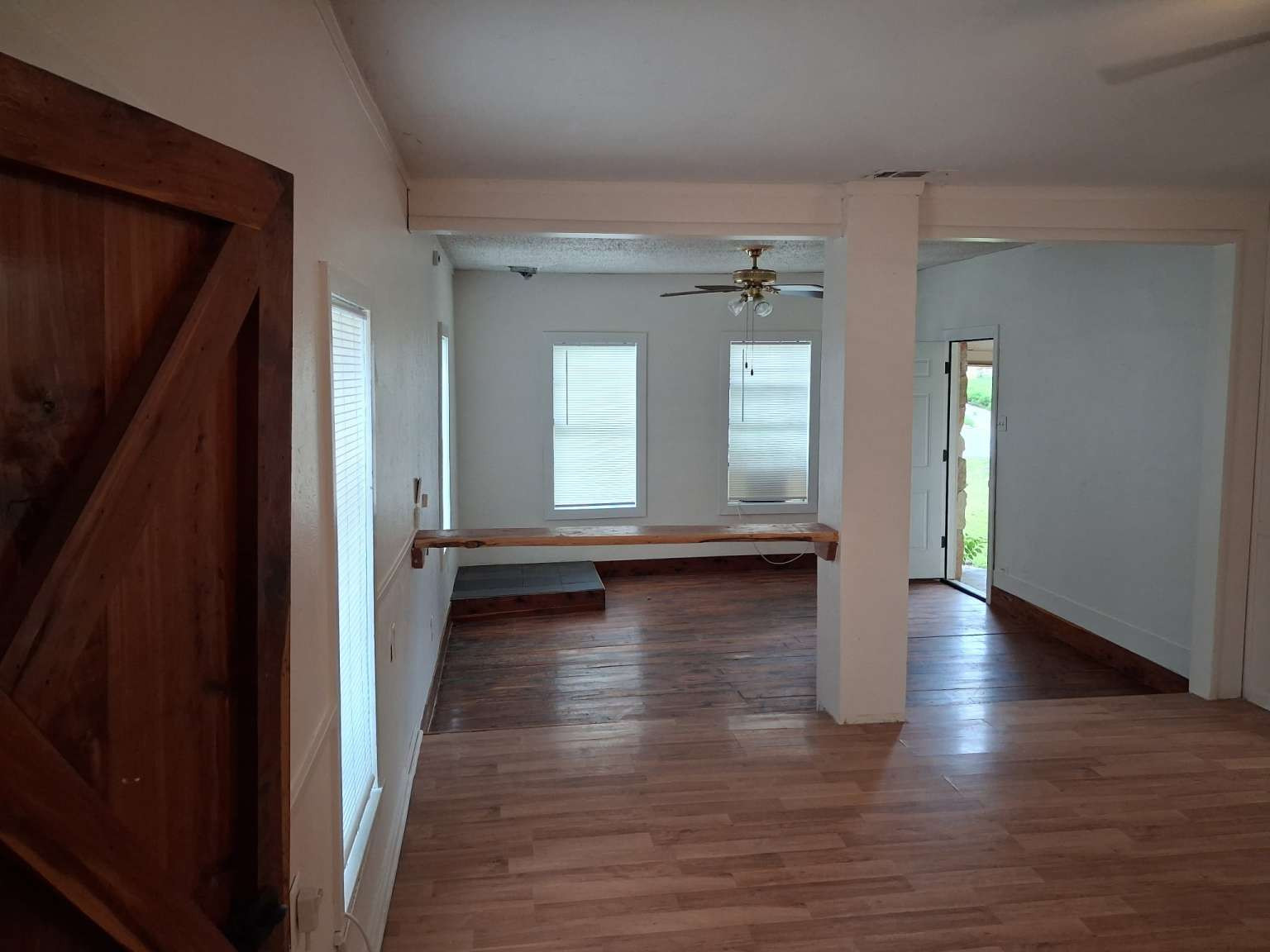 308 North Ridge Street Lampasas, TX 76550 - Photo 8 of 16 an empty room with wooden floor and windows