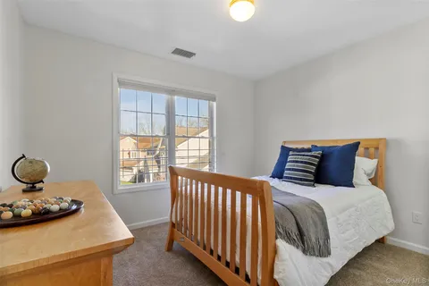 a bed sitting in a bedroom next to a window