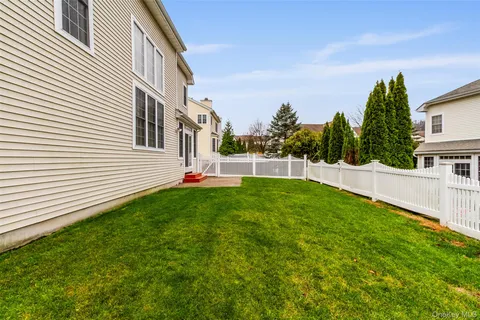 a view of a house with a yard and sitting area