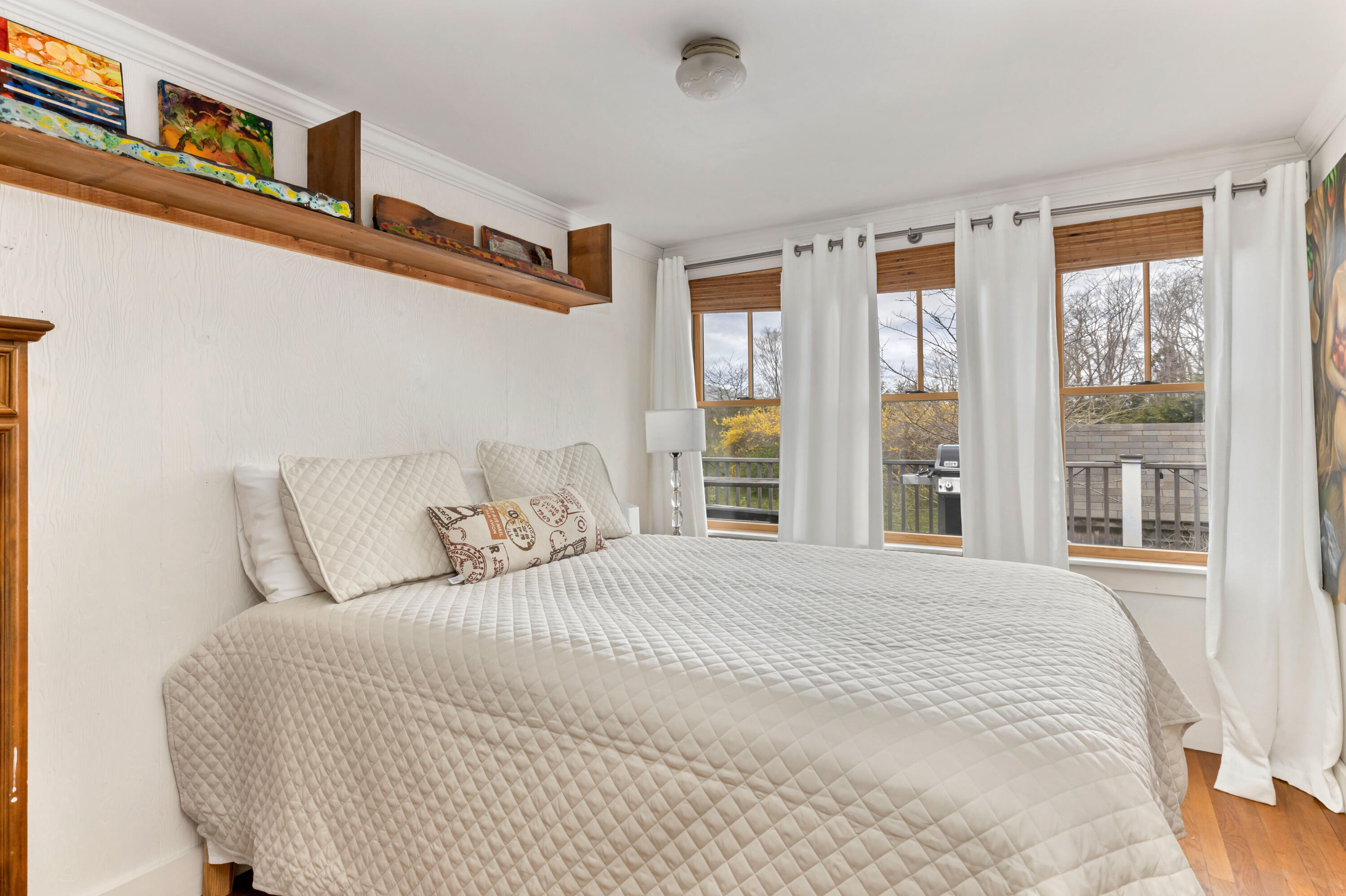 65 Depot Road Truro, MA 02666 - Photo 16 of 37 a bedroom with a large bed and two windows