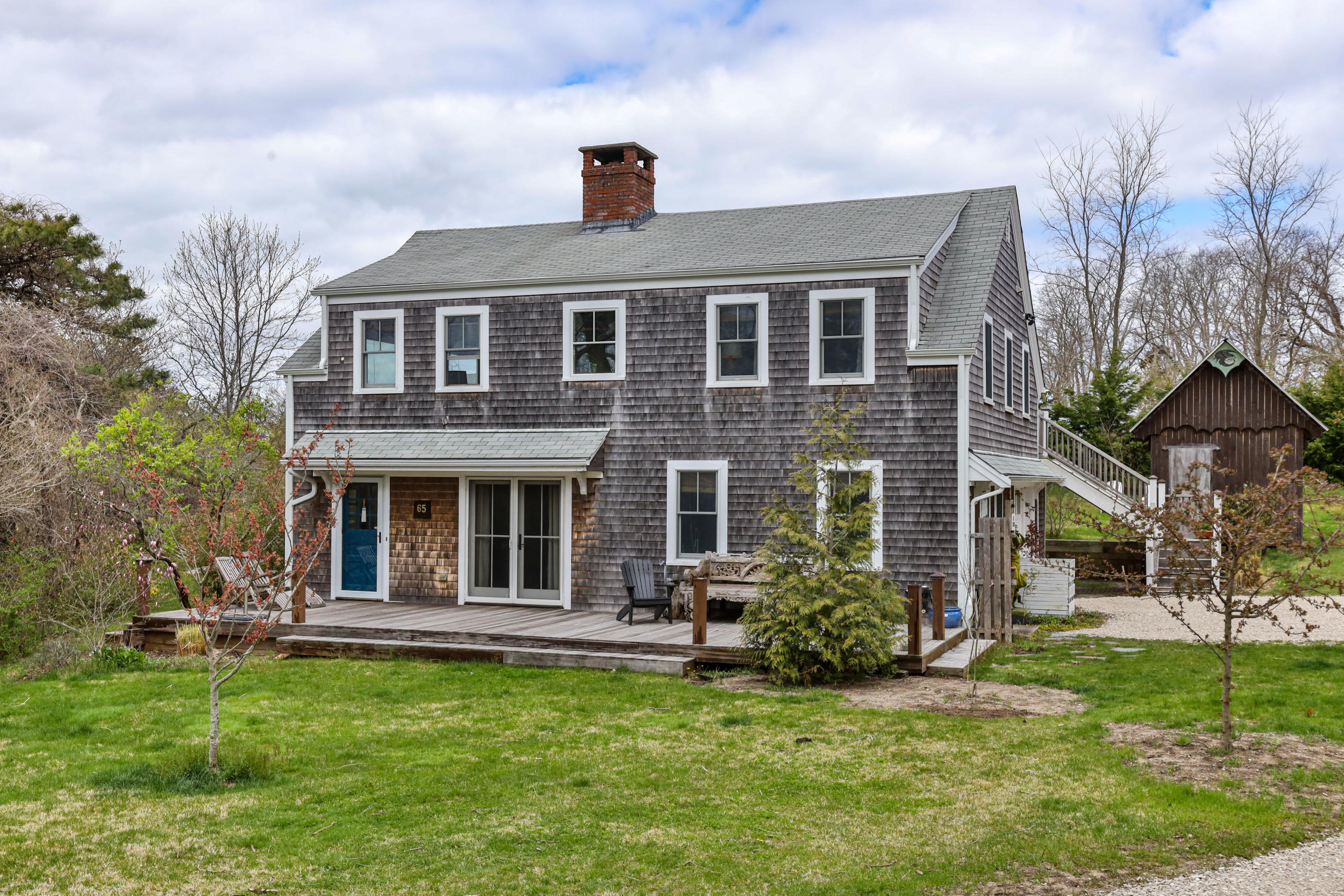 65 Depot Road Truro, MA 02666 - Photo 2 of 37 a front view of a house with a garden