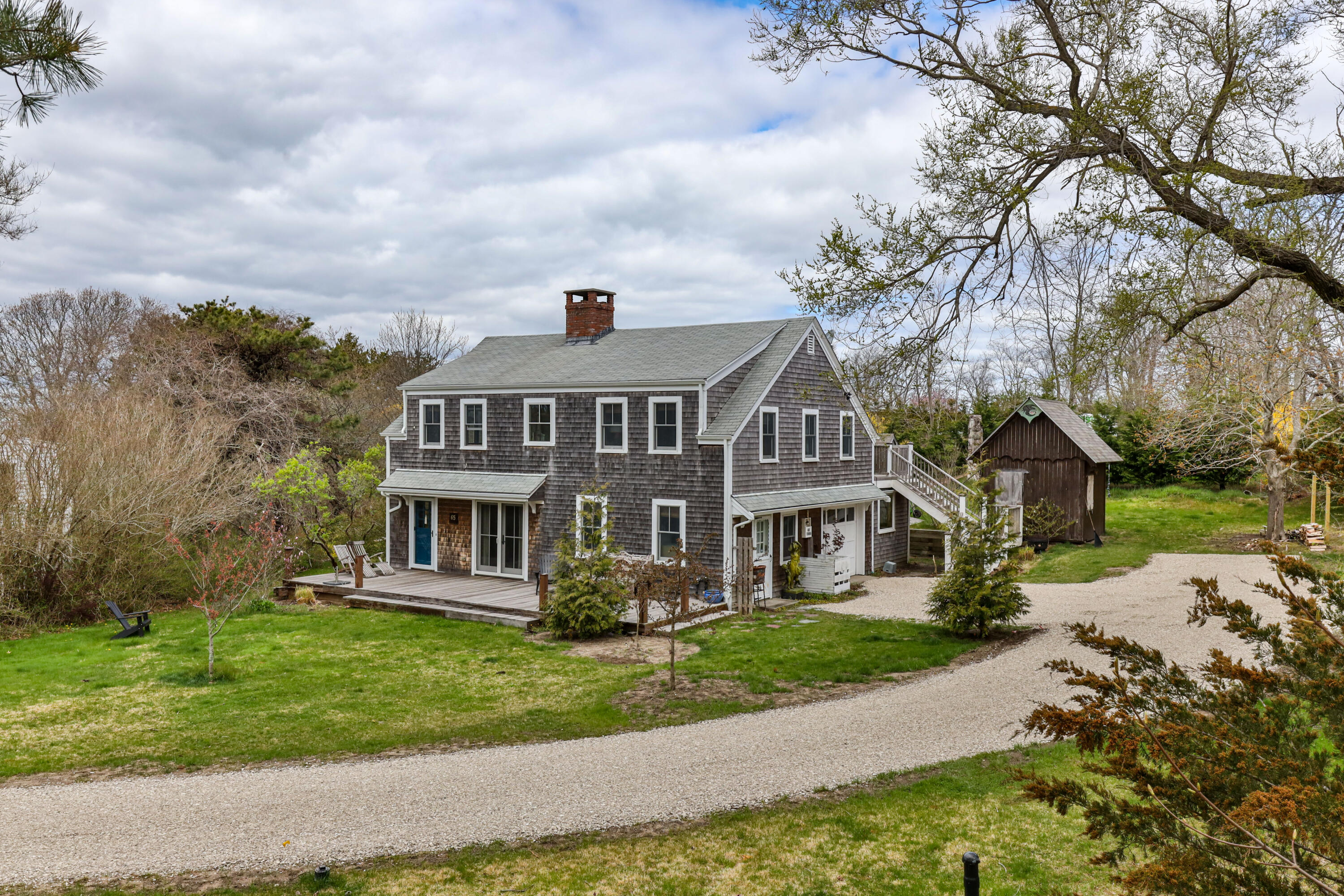 65 Depot Road Truro, MA 02666 - Photo 3 of 37 an aerial view of a house with a yard and large trees