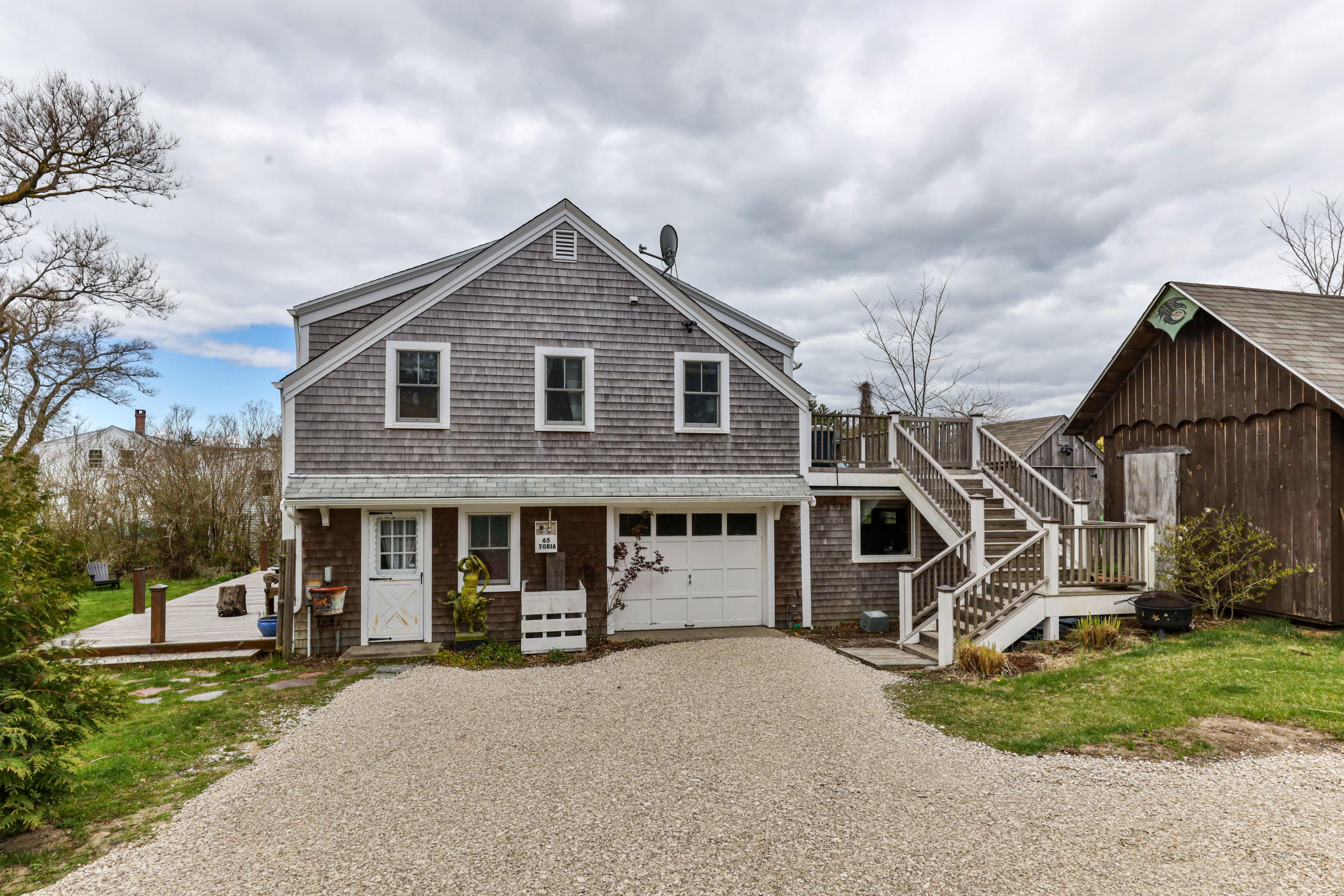 65 Depot Road Truro, MA 02666 - Photo 4 of 37 a front view of a house with a yard