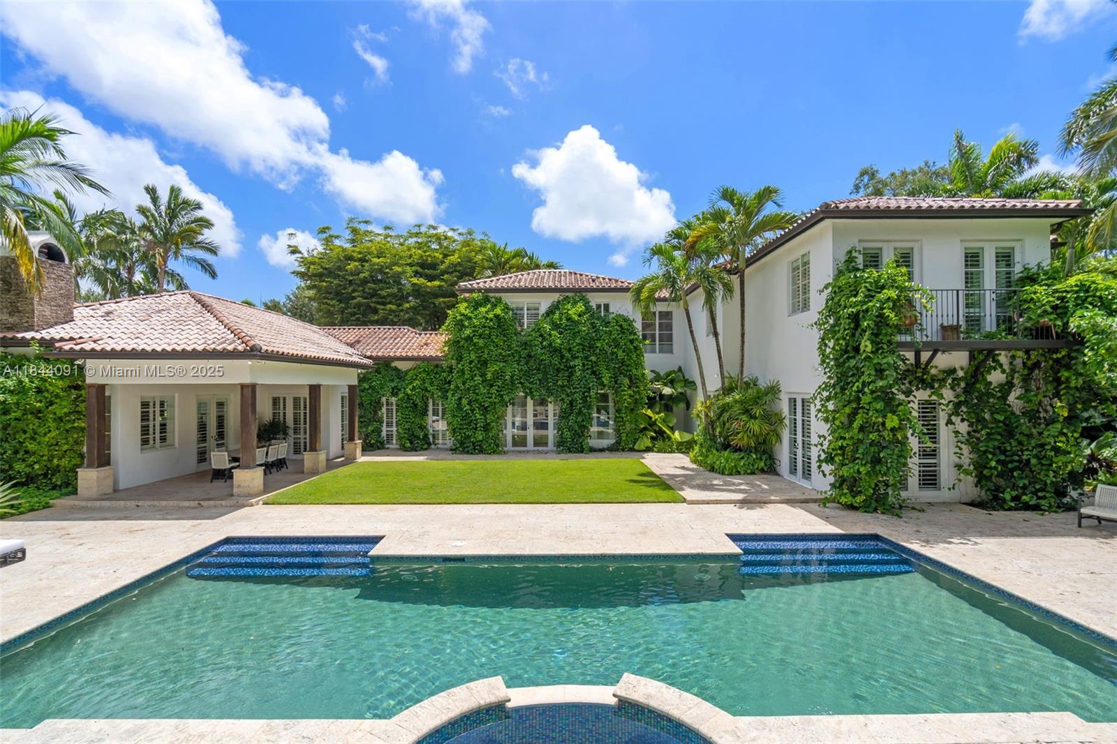 a view of a house with swimming pool and yard