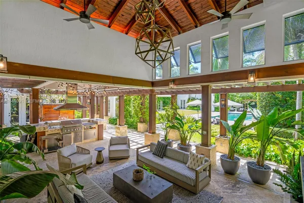 a view of a patio with a dining table and chairs with wooden fence