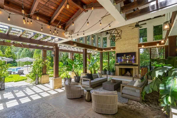 a living room with furniture potted plant and a large window