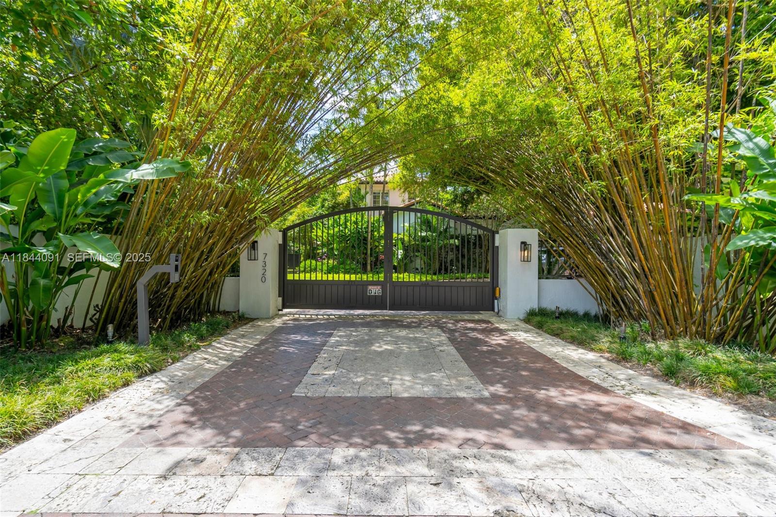7320 Southwest 79th Court Miami, FL 33143 - Photo 19 of 89 a view of a road with plants and large trees