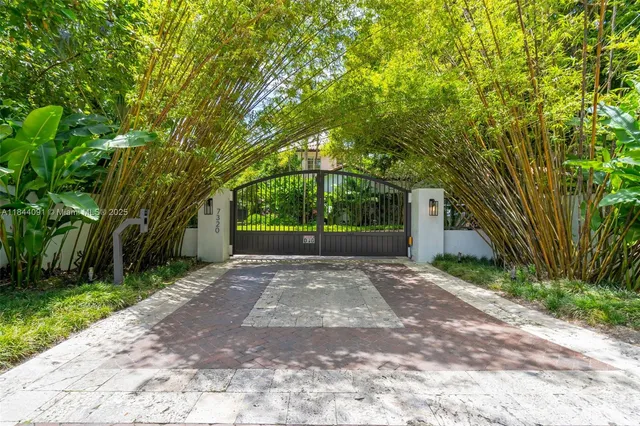 a living room with furniture potted plant and a large window