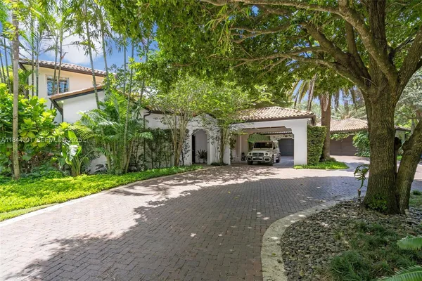 a living room with furniture a clock and a large window