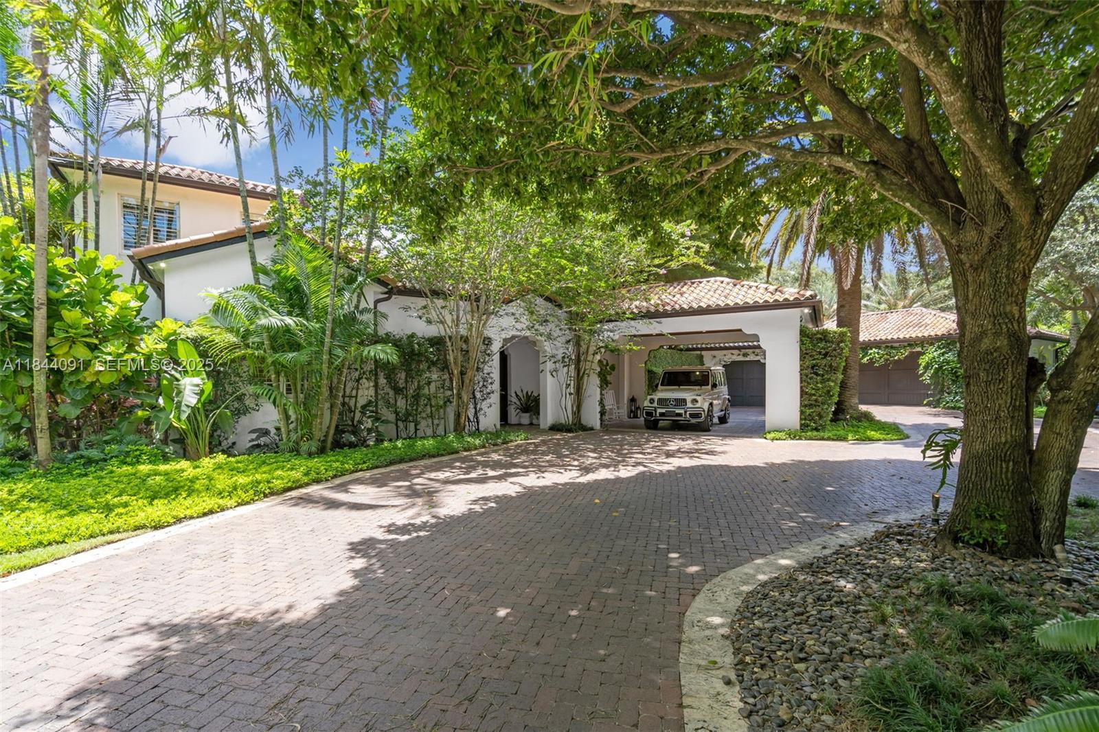 7320 Southwest 79th Court Miami, FL 33143 - Photo 20 of 89 a front view of a house with a garden and trees