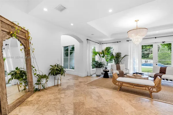 a spacious bedroom with a bed and a chandelier