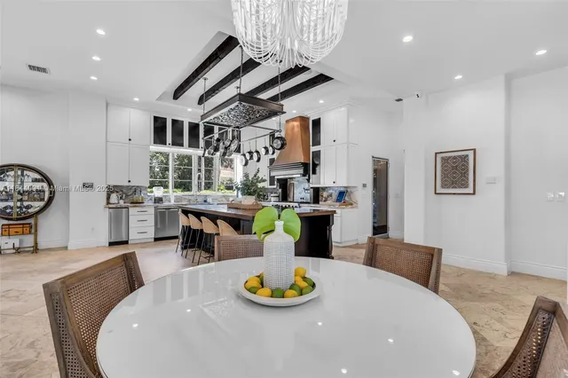 a bedroom with furniture and a large window