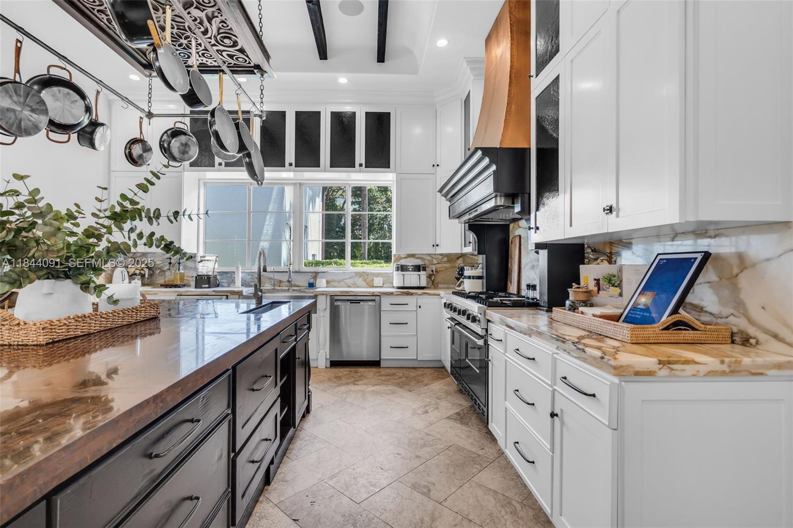 7320 Southwest 79th Court Miami, FL 33143 - Photo 42 of 89 a kitchen with stainless steel appliances granite countertop a sink a stove and a wooden floors