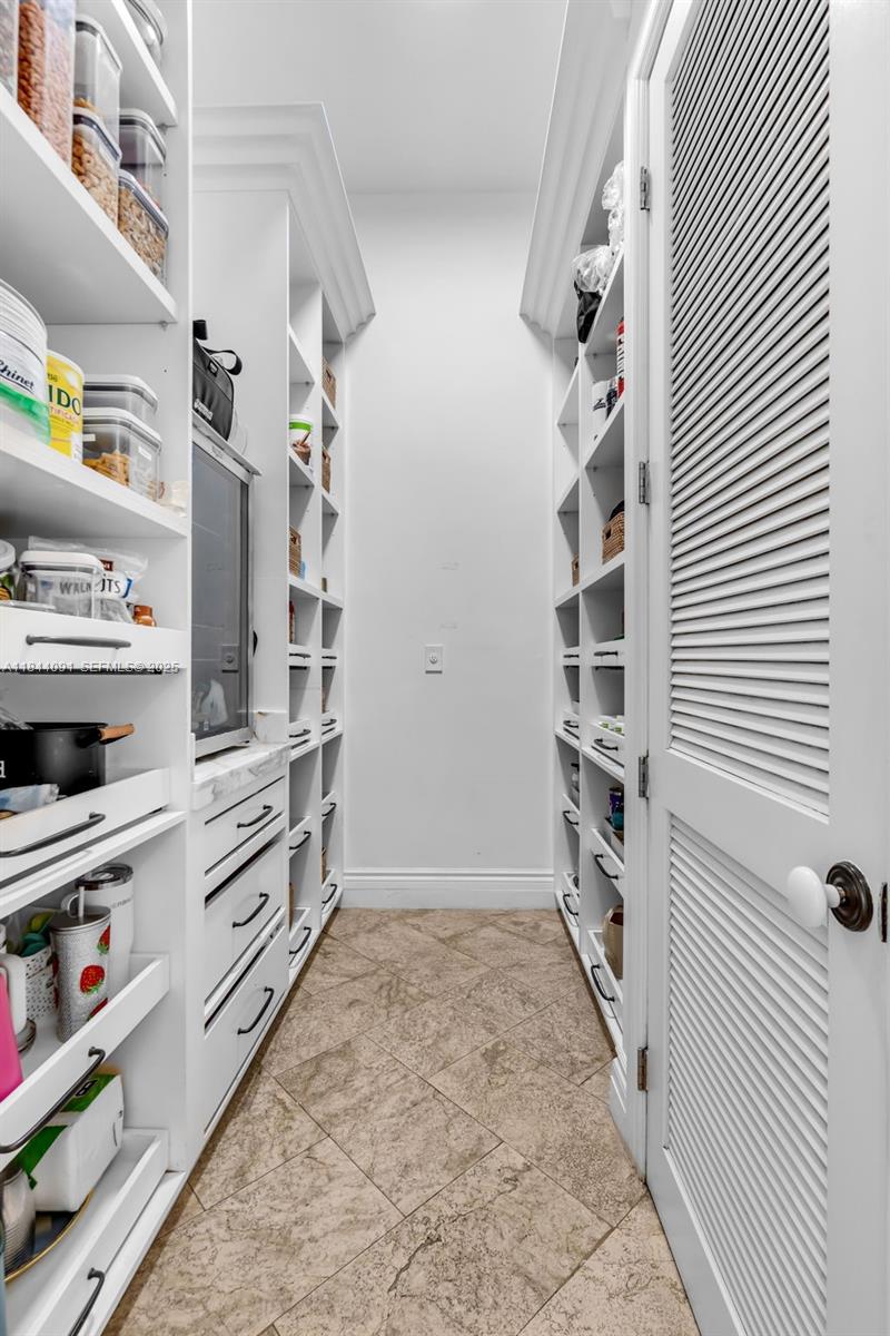 7320 Southwest 79th Court Miami, FL 33143 - Photo 44 of 89 a view of walk in closet with clothes and shoes