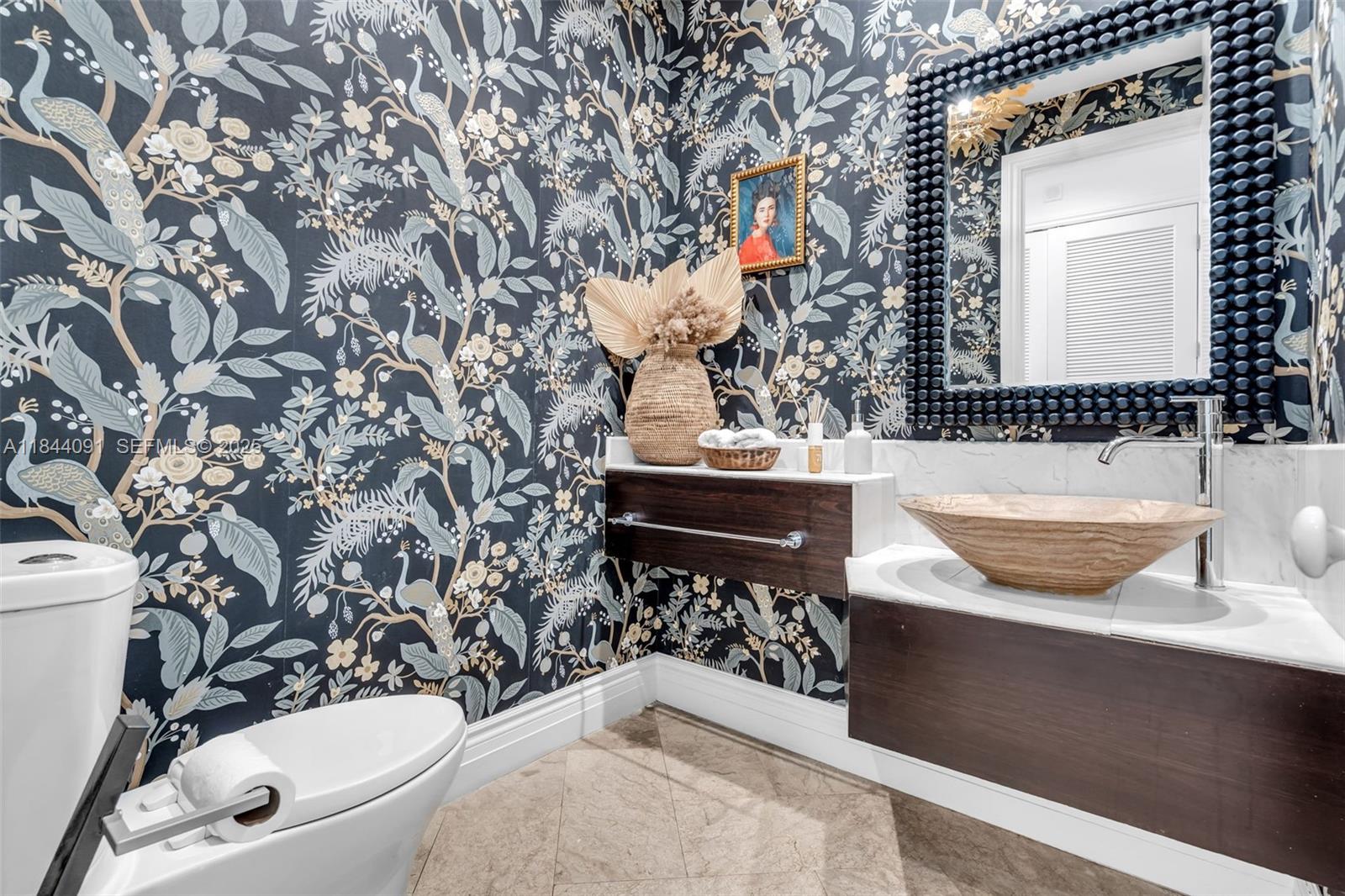 7320 Southwest 79th Court Miami, FL 33143 - Photo 47 of 89 a bathroom with a toilet a sink and a mirror