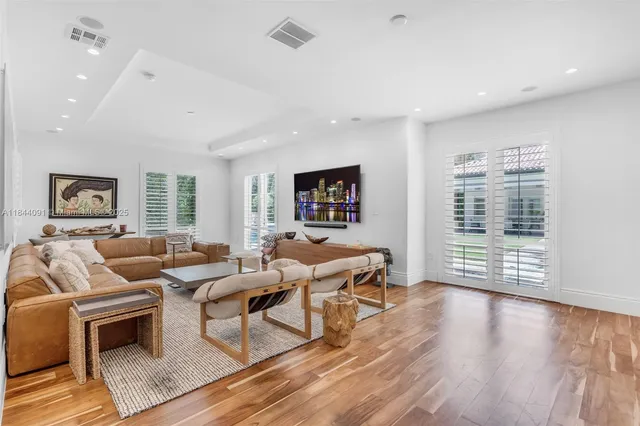 an aerial view of residential houses with outdoor space and street view
