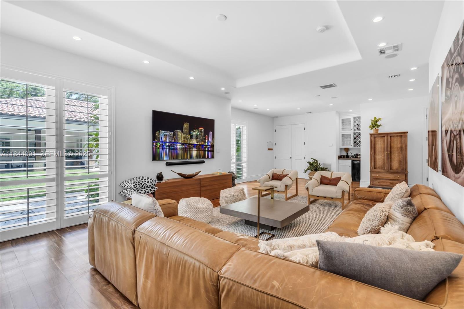7320 Southwest 79th Court Miami, FL 33143 - Photo 49 of 89 a living room with furniture and a flat screen tv