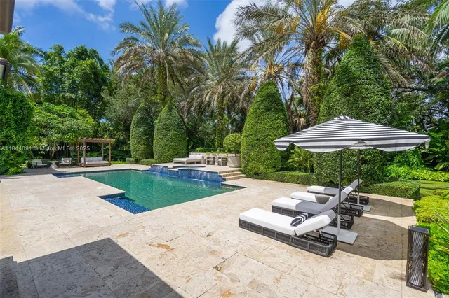a view of a house with swimming pool and a yard