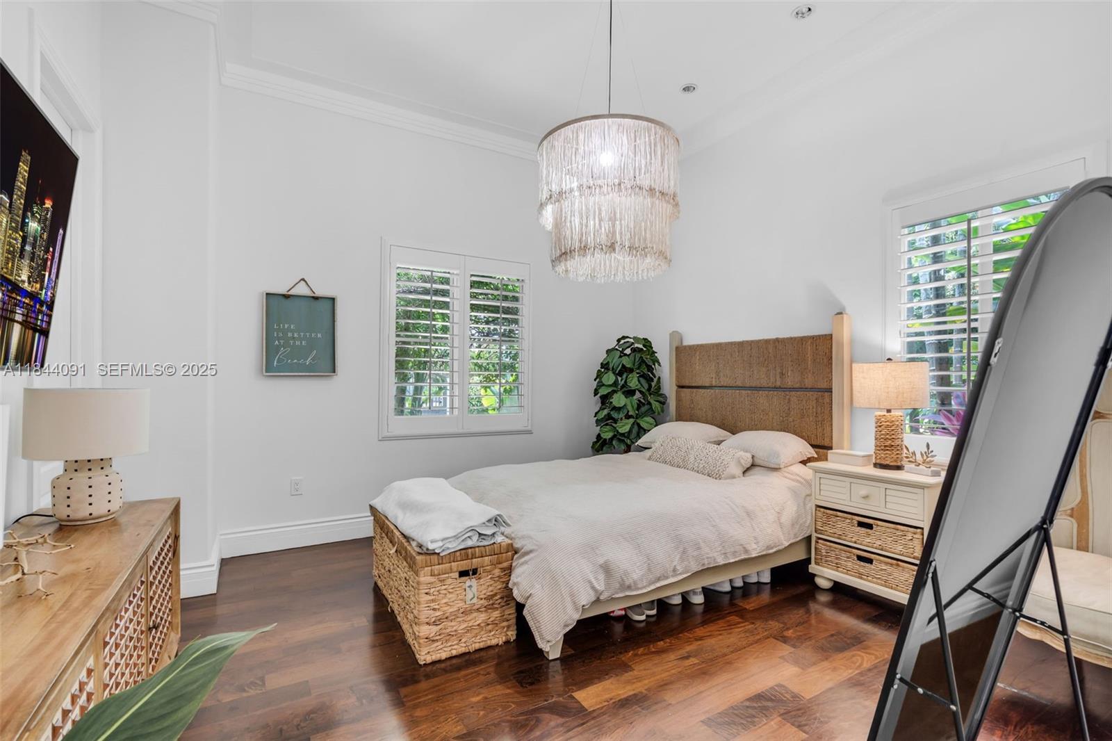 7320 Southwest 79th Court Miami, FL 33143 - Photo 51 of 89 a spacious bedroom with a bed and a chandelier