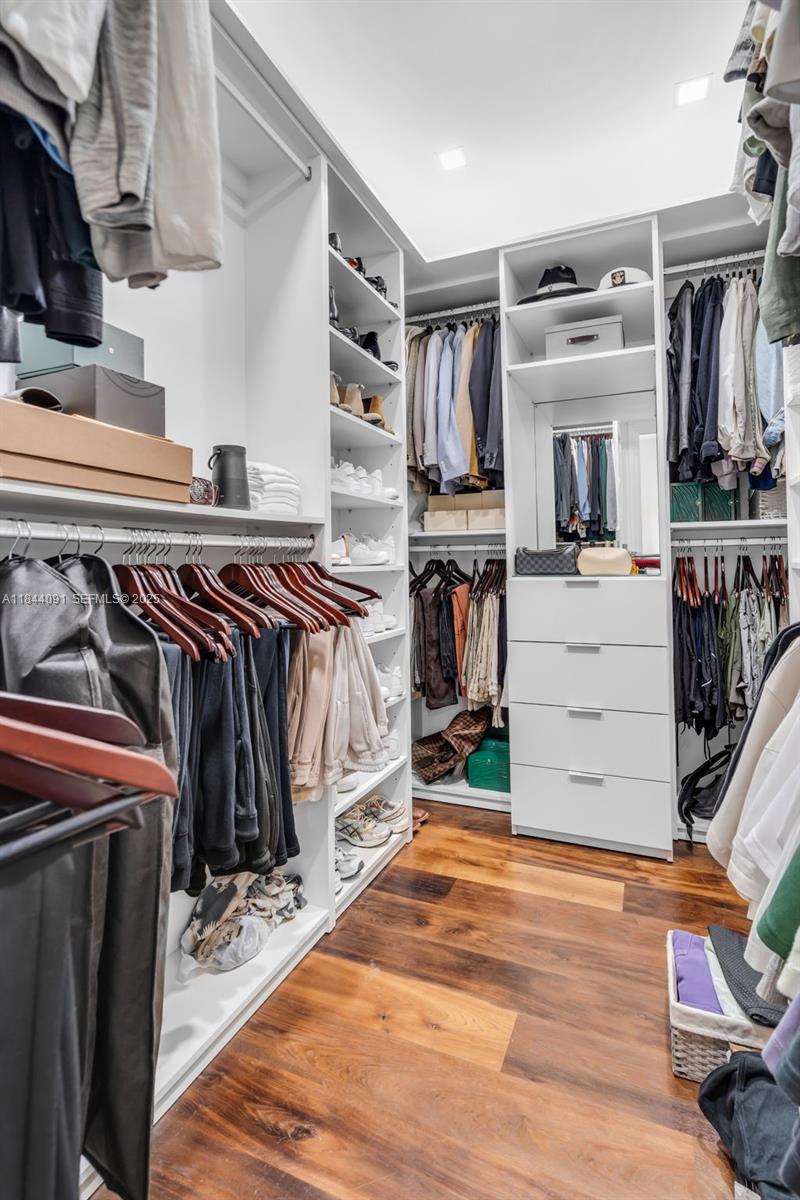 7320 Southwest 79th Court Miami, FL 33143 - Photo 69 of 89 a view of walk in closet with clothes and shoes