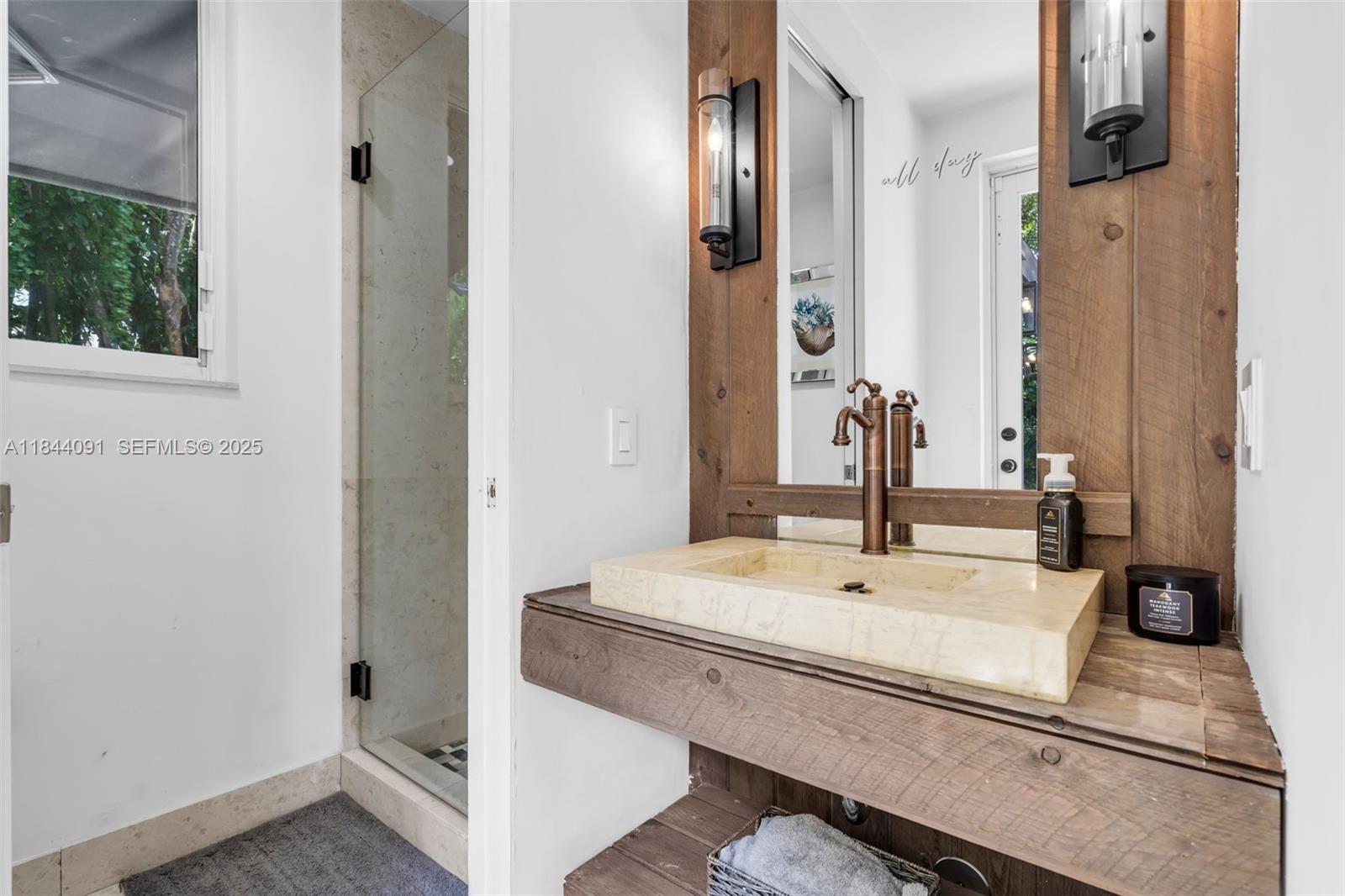 7320 Southwest 79th Court Miami, FL 33143 - Photo 75 of 89 a bathroom with a sink and mirror