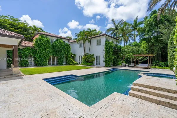 a dining room with furniture and a potted plant