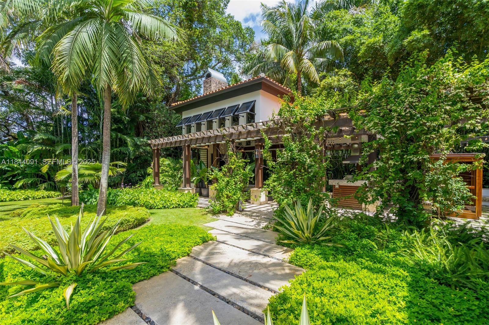 7320 Southwest 79th Court Miami, FL 33143 - Photo 10 of 89 a house view with a garden space