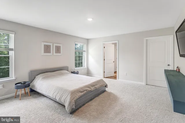 a spacious bedroom with a bed and a window