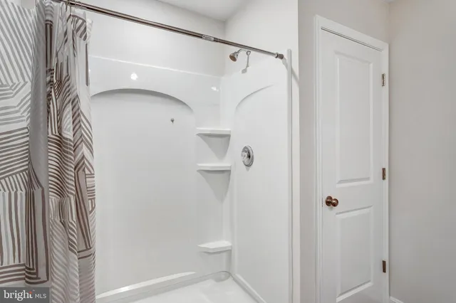 a bathroom with a shower and a toilet