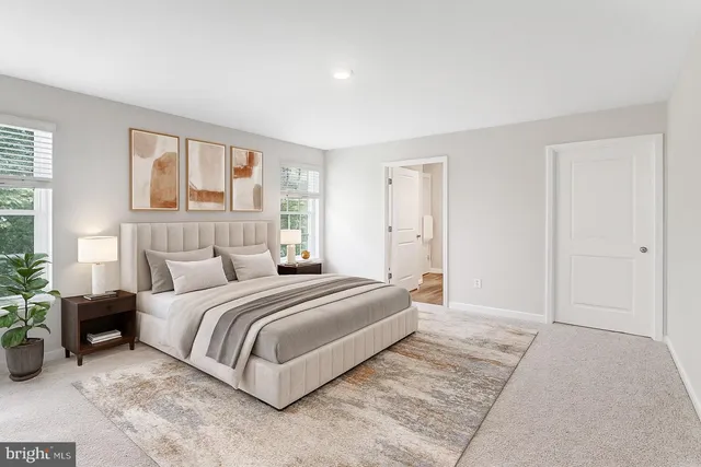 a spacious bedroom with a bed and a couch