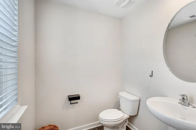 a white toilet sitting next to a white sink