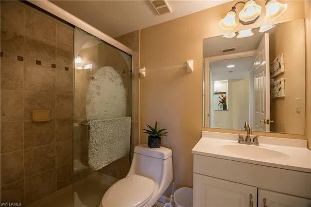 a spacious bedroom with a bed and a flat screen tv