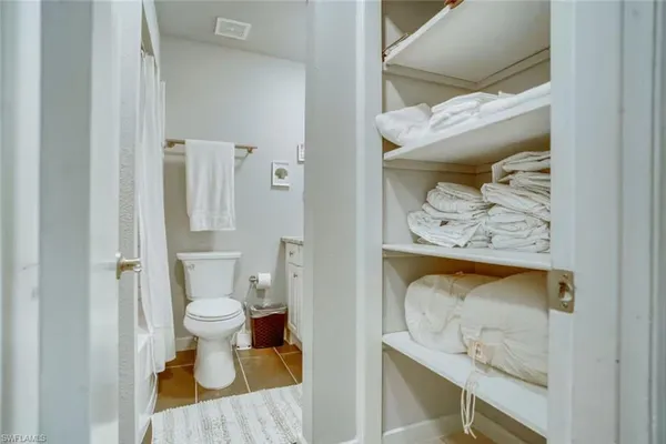 a bathroom with a toilet and a shower curtain