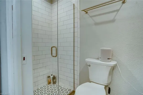 a bathroom with a toilet and a shower