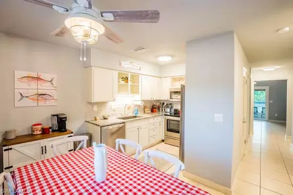 a open kitchen with stainless steel appliances kitchen island granite countertop a sink and cabinets