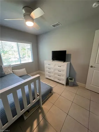 a bedroom with furniture and a flat screen tv
