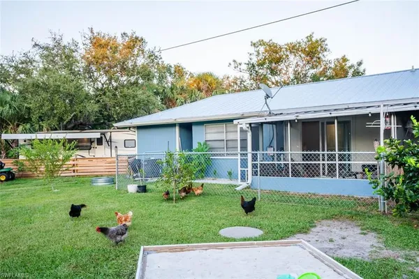 a front view of a house with a yard table and chairs