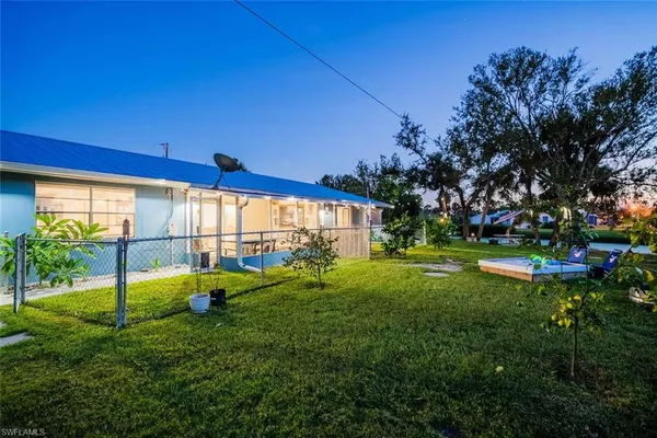 a view of yard with swimming pool and green space