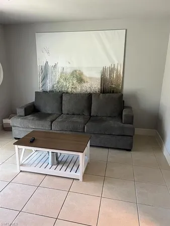 a living room with furniture and a painting