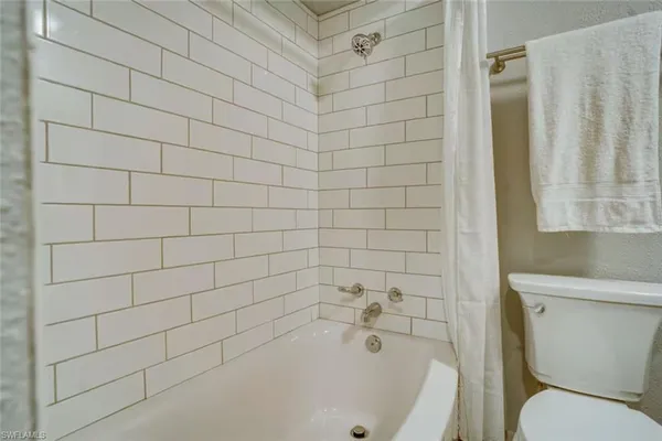 a bathroom with a bathtub and toilet