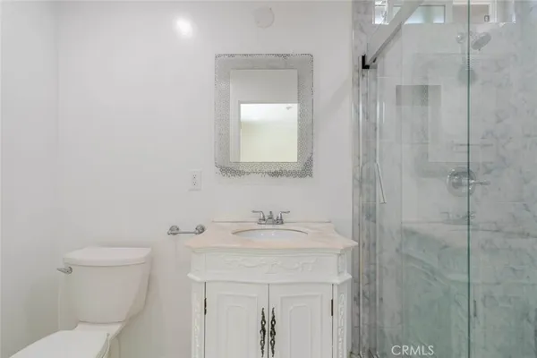 a bathroom with a sink vanity and toilet