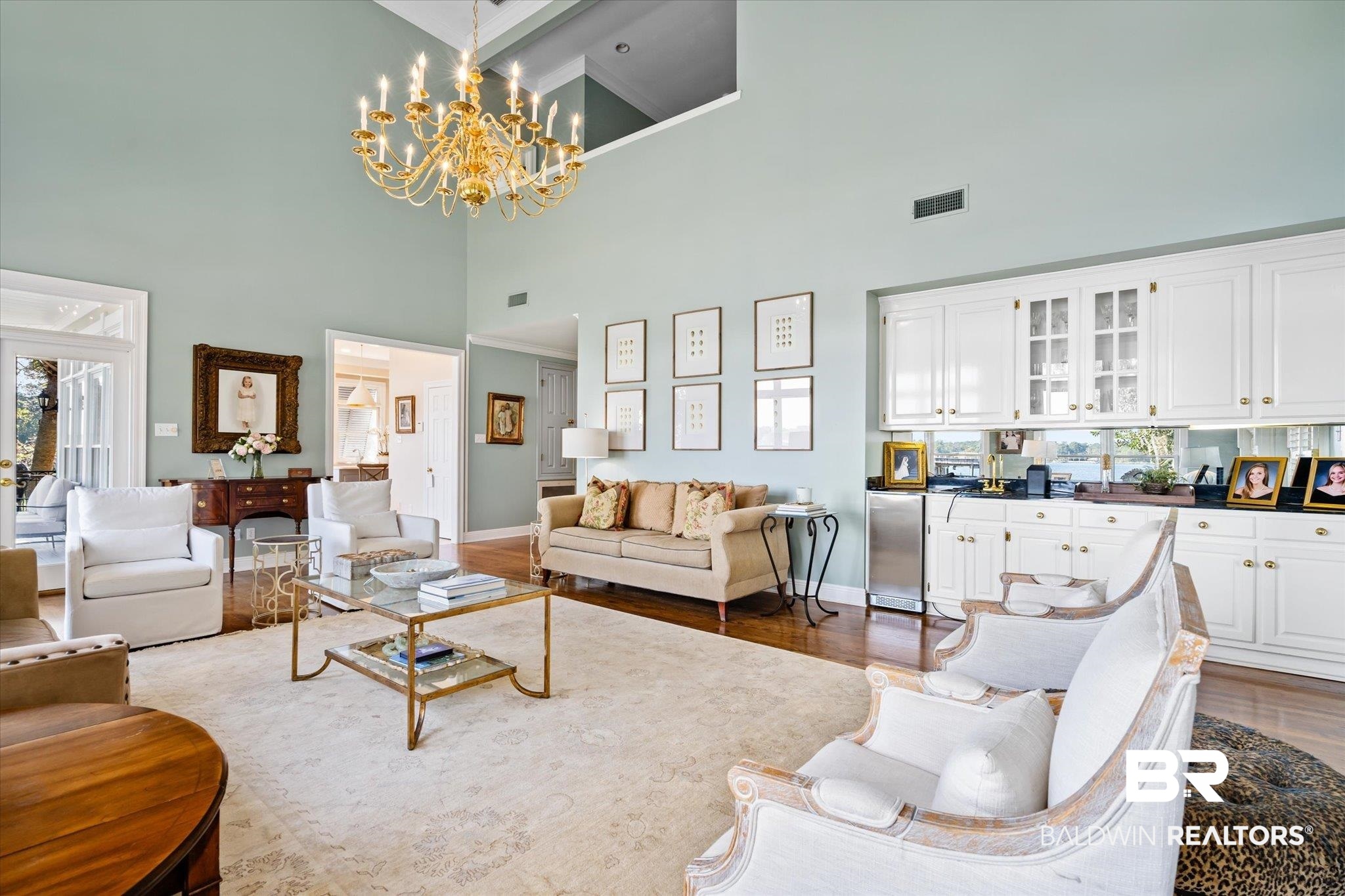 4930 River Trace Theodore, AL 36582 - Photo 9 of 57 Living room with a notable chandelier, a towering ceiling, wood-type flooring, and beamed ceiling