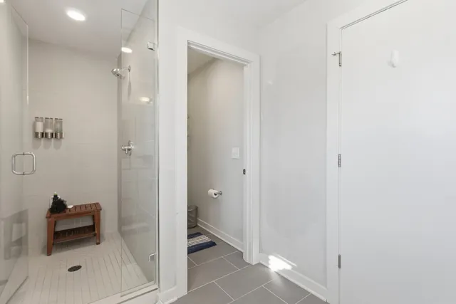 a bathroom with a shower and a glass door
