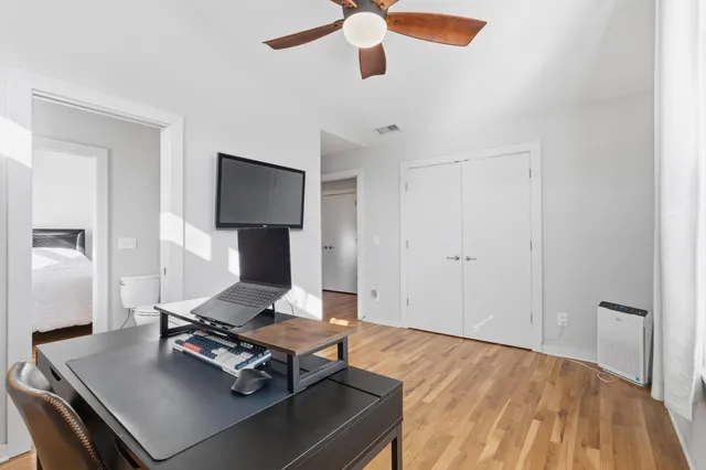 a living room with a bed furniture and a flat screen tv