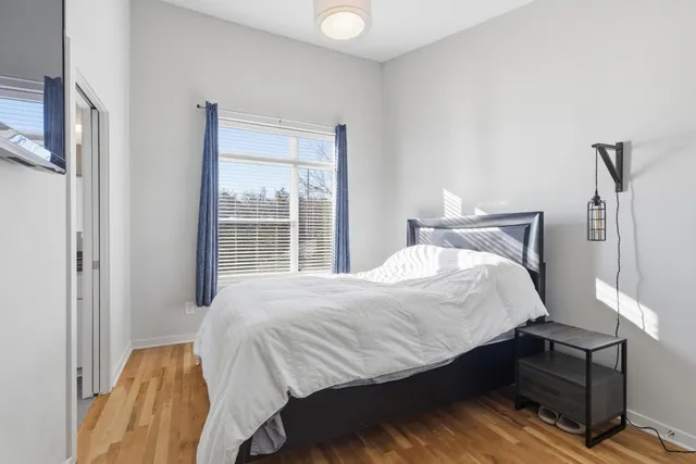 a bedroom with a bed and window