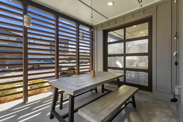 a view of a workspace with furniture and window